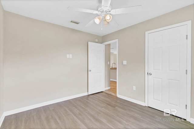 15030 Marem Dr, Foley, AL 36535 - unfurnished bedroom with wood finished floors and ceiling fan