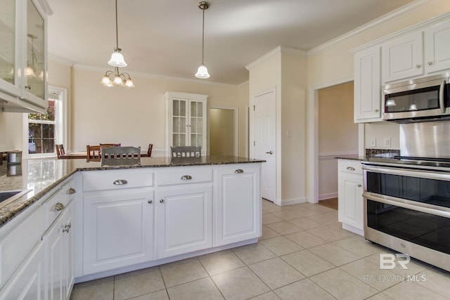 kitchen with white cabinetry, ornamental molding, appliances with stainless steel finishes, and pendant lighting