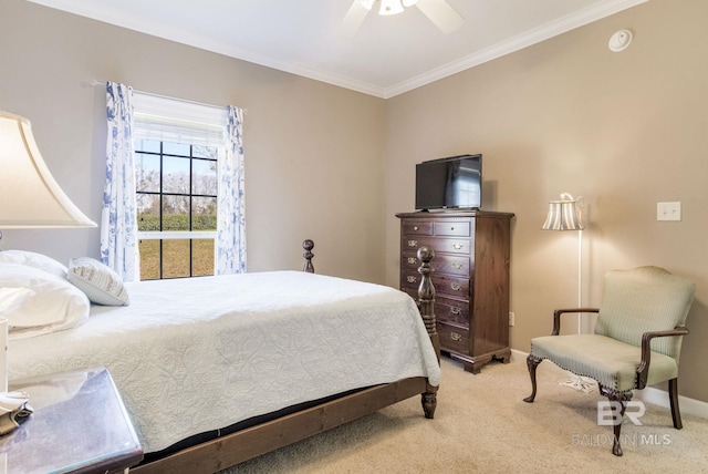 carpeted bedroom with ceiling fan and crown molding