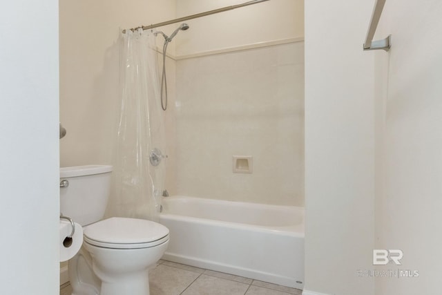 bathroom featuring tile patterned floors, shower / bath combo with shower curtain, and toilet