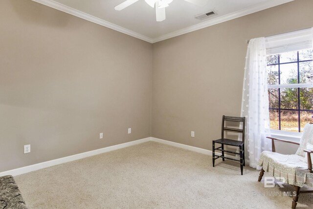 sitting room with carpet, crown molding, and ceiling fan