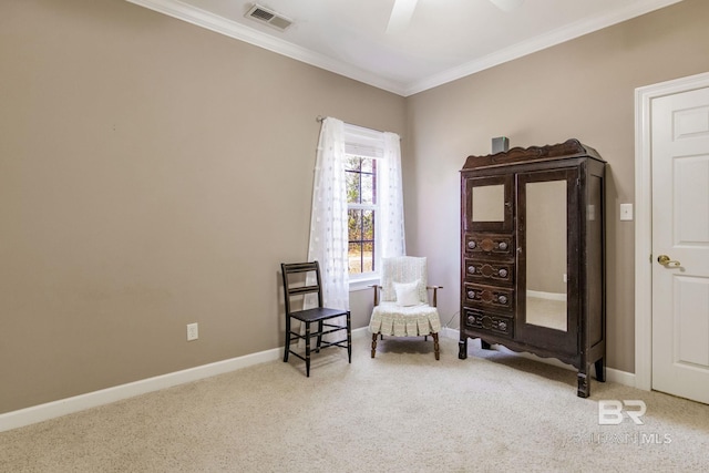 sitting room featuring ceiling fan, ornamental molding, and light carpet
