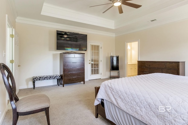 carpeted bedroom featuring ensuite bathroom, ceiling fan, a tray ceiling, and ornamental molding