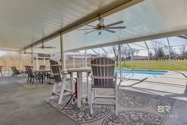view of patio / terrace with ceiling fan and glass enclosure