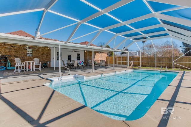 view of pool featuring a patio, ceiling fan, and a lanai