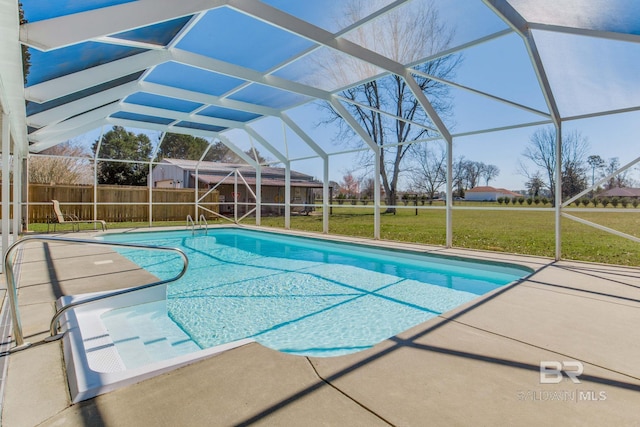 view of pool featuring a yard, glass enclosure, and a patio