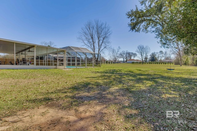 view of yard with glass enclosure