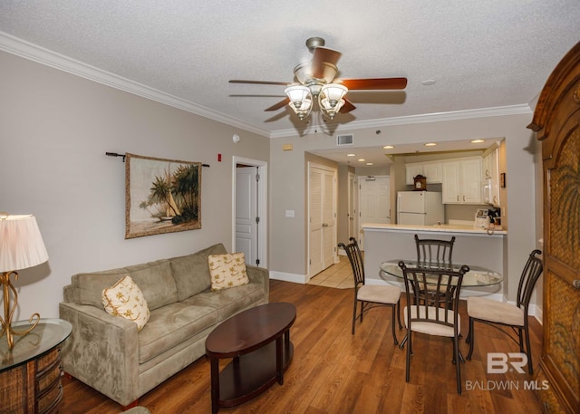 22984 Perdido Beach Blvd Unit A23, Orange Beach, AL 36561 - living area featuring a ceiling fan, wood finished floors, ornamental molding, a textured ceiling, and baseboards