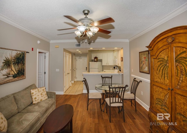 22984 Perdido Beach Blvd Unit A23, Orange Beach, AL 36561 - dining space featuring ceiling fan, light wood-style flooring, a textured ceiling, crown molding, and baseboards