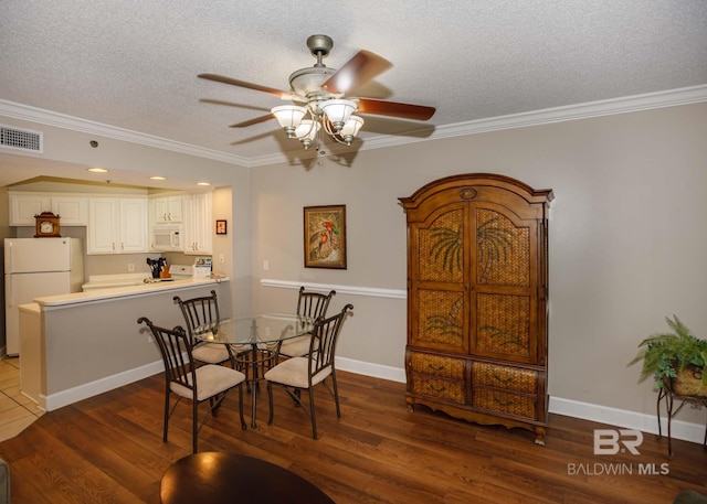 22984 Perdido Beach Blvd Unit A23, Orange Beach, AL 36561 - dining space featuring a ceiling fan, a textured ceiling, wood finished floors, ornamental molding, and baseboards