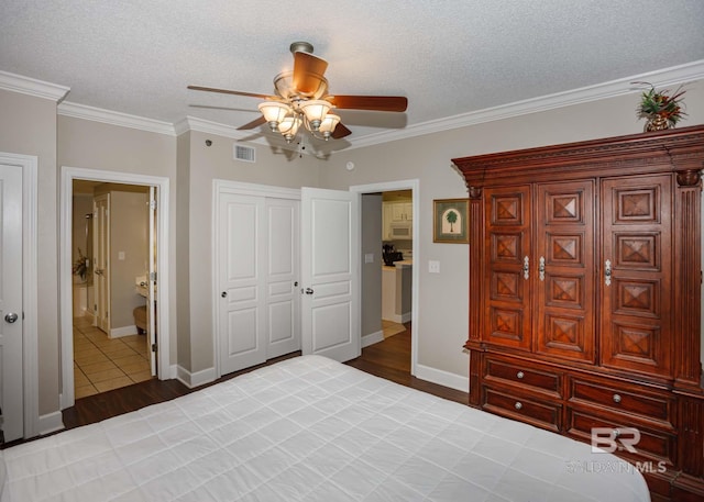 22984 Perdido Beach Blvd Unit A23, Orange Beach, AL 36561 - bedroom featuring wood finished floors, ornamental molding, baseboards, ceiling fan, and a closet