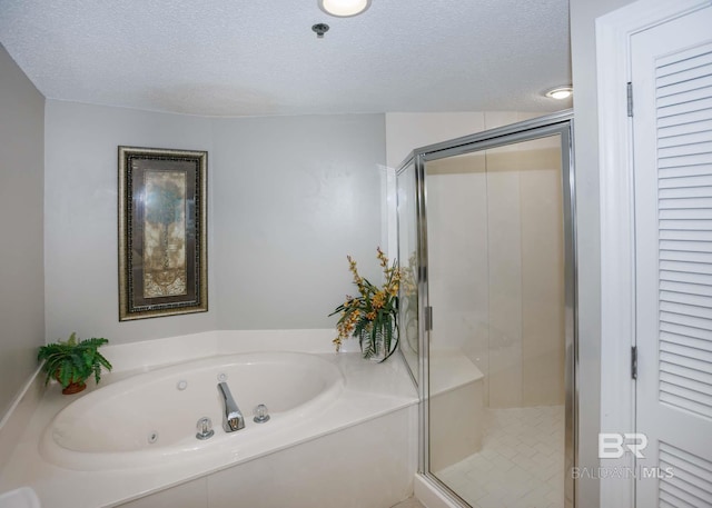 22984 Perdido Beach Blvd Unit A23, Orange Beach, AL 36561 - full bath with a jetted tub, a shower stall, and a textured ceiling