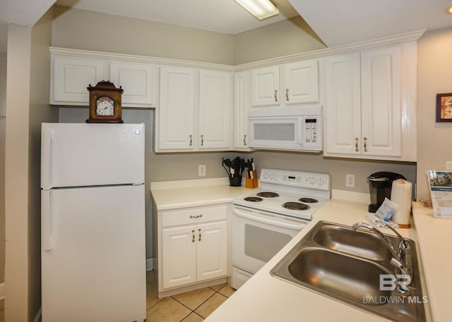 22984 Perdido Beach Blvd Unit A23, Orange Beach, AL 36561 - kitchen with white appliances, a sink, and white cabinetry