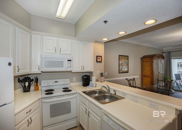 22984 Perdido Beach Blvd Unit A23, Orange Beach, AL 36561 - kitchen with white appliances, a sink, white cabinetry, a peninsula, and light countertops