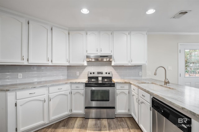 kitchen with white cabinets, stainless steel appliances, ornamental molding, and sink