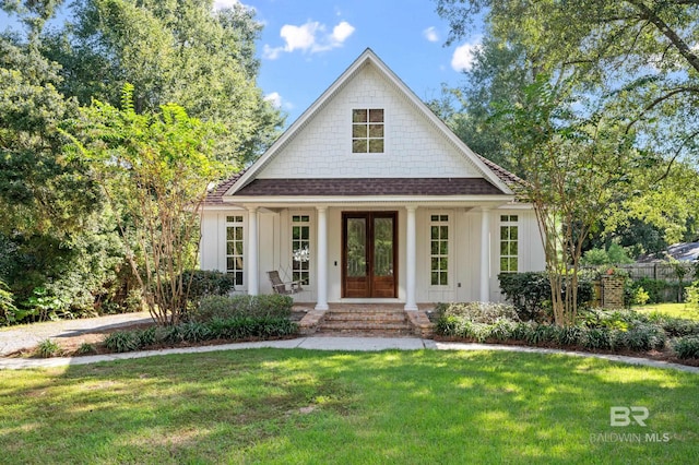 view of front facade with covered porch and a front yard