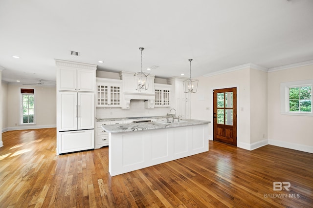 kitchen with white cabinets, light wood-type flooring, and plenty of natural light