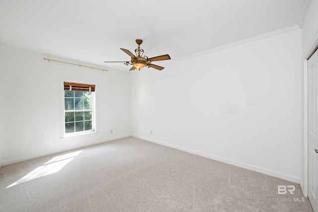 carpeted empty room with crown molding and ceiling fan