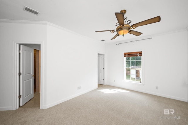 carpeted spare room with ornamental molding and ceiling fan