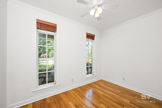 empty room with crown molding, ceiling fan, and hardwood / wood-style flooring