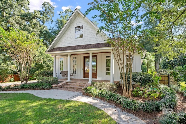 view of front of home featuring a front yard and covered porch