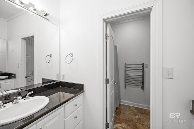 bathroom featuring ornamental molding and vanity