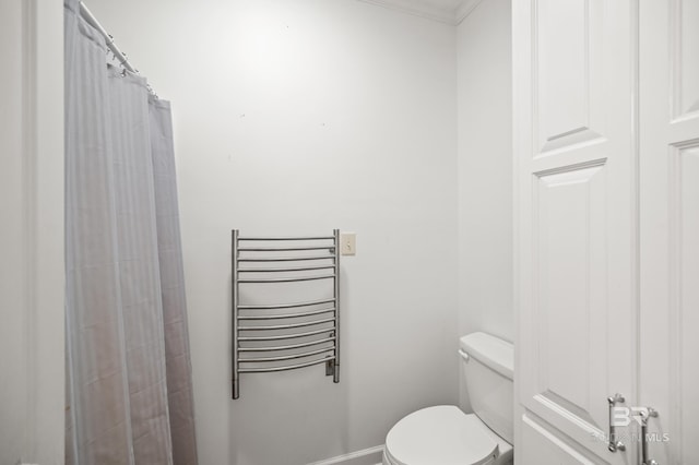 bathroom with radiator, crown molding, curtained shower, and toilet