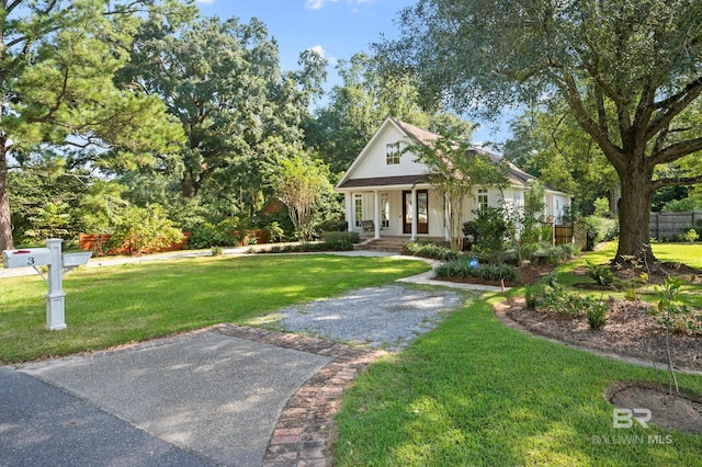 view of front of home featuring covered porch and a front yard