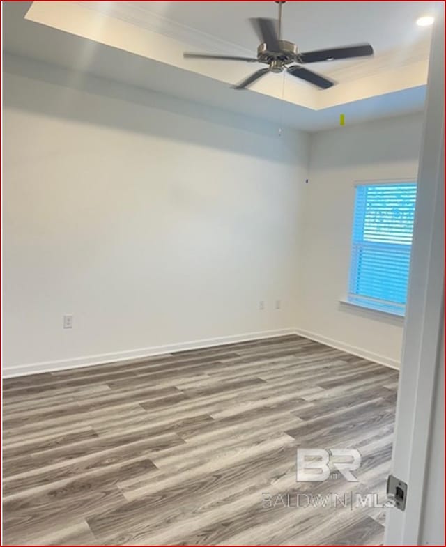 spare room featuring ceiling fan and hardwood / wood-style floors