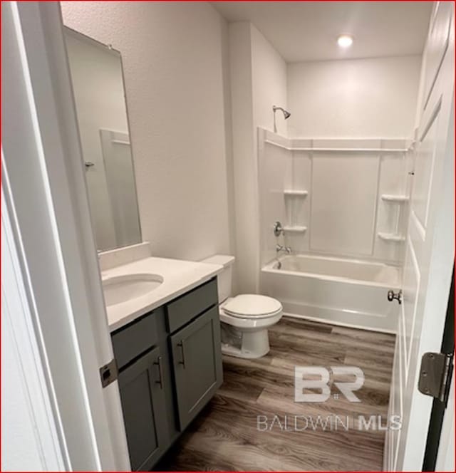 full bathroom featuring vanity, toilet, wood-type flooring, and bathing tub / shower combination