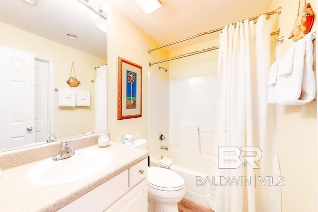 full bathroom with vanity, shower / bathtub combination with curtain, and toilet