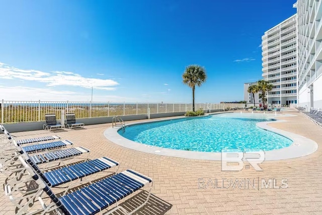 view of swimming pool featuring a patio area