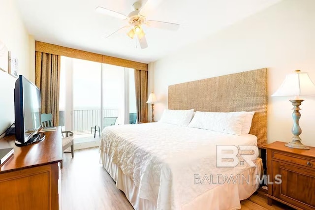 bedroom featuring ceiling fan, light wood-type flooring, and access to outside