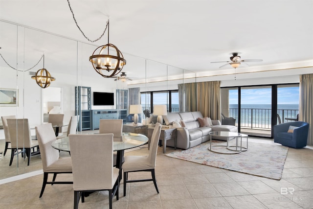 dining space featuring light tile patterned floors and ceiling fan with notable chandelier