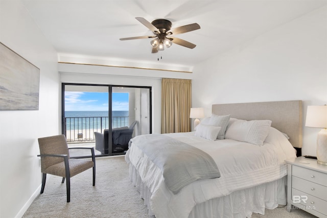 bedroom with access to exterior, a water view, light carpet, ceiling fan, and baseboards