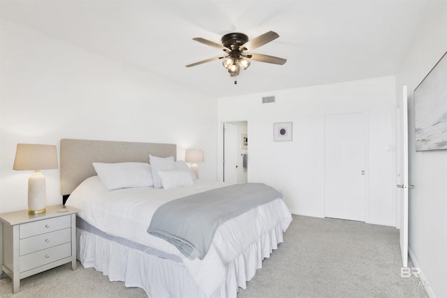 bedroom with a ceiling fan, visible vents, and light carpet