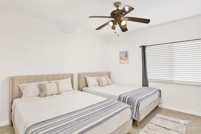 bedroom featuring baseboards and a ceiling fan