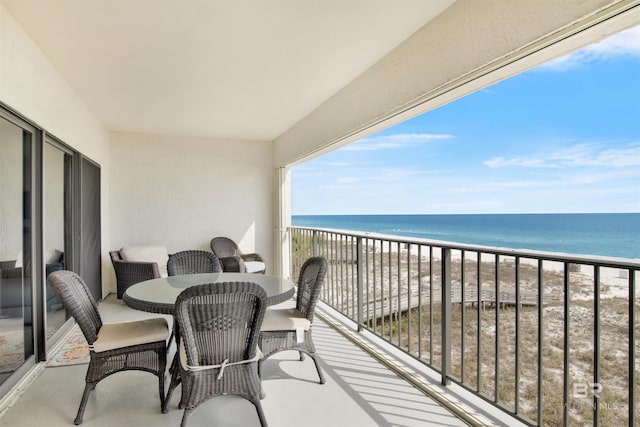 balcony with a beach view and a water view