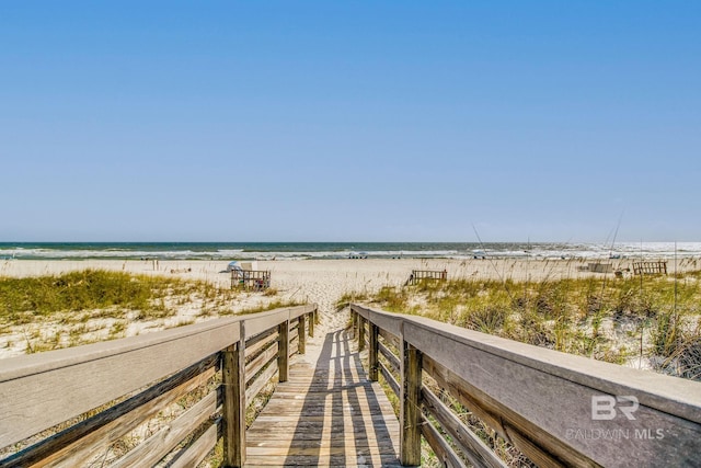 view of property's community with a view of the beach and a water view