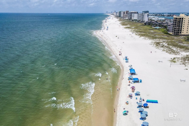 drone / aerial view with a water view and a beach view