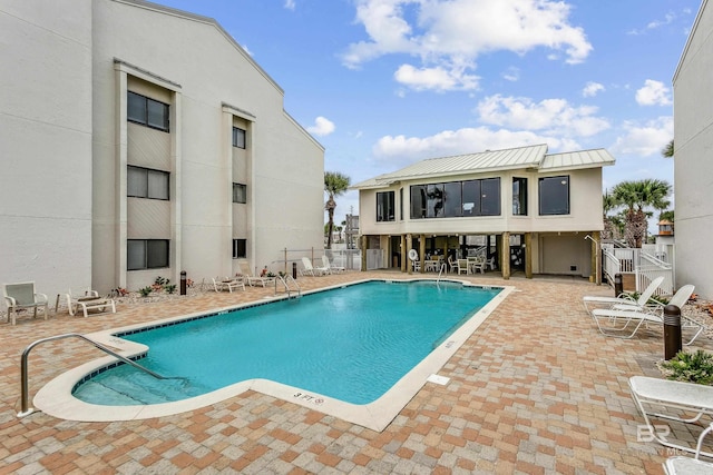 community pool featuring a patio and fence