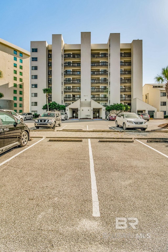 view of building exterior with uncovered parking