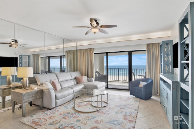 living room featuring ceiling fan and light tile patterned flooring