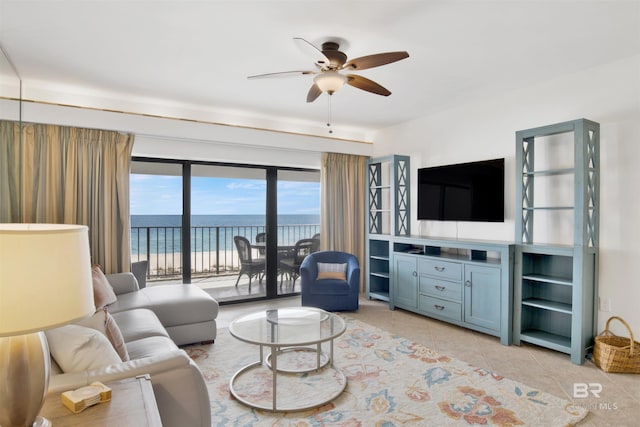 living area with light tile patterned floors and a ceiling fan