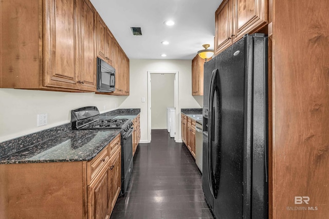 566 Stuart St, Daphne, AL 36526 - kitchen featuring black appliances, brown cabinets, recessed lighting, baseboards, and dark stone counters