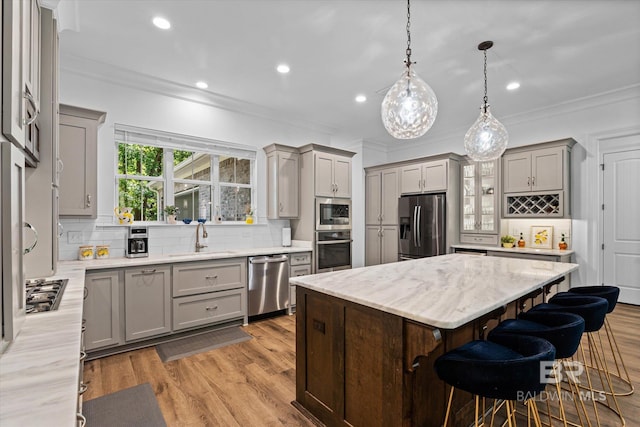 3250 Riviere Du Chien Rd, Mobile, AL 36693 - kitchen with gray cabinets, appliances with stainless steel finishes, crown molding, decorative backsplash, and recessed lighting