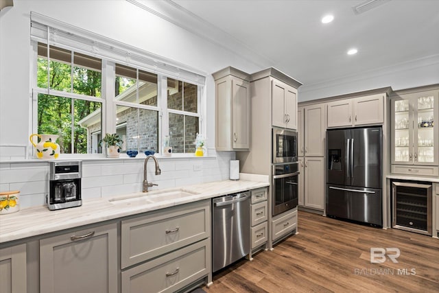 3250 Riviere Du Chien Rd, Mobile, AL 36693 - kitchen with stainless steel appliances, wine cooler, a sink, gray cabinetry, and ornamental molding