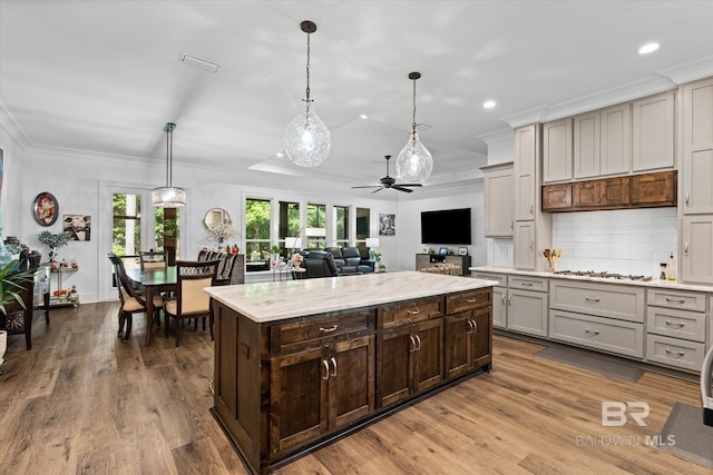 3250 Riviere Du Chien Rd, Mobile, AL 36693 - kitchen featuring ceiling fan, tasteful backsplash, crown molding, wood finished floors, and decorative light fixtures