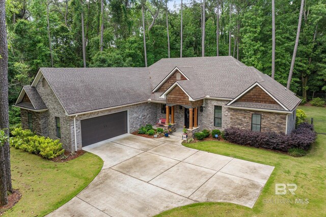 3250 Riviere Du Chien Rd, Mobile, AL 36693 - craftsman-style house with a garage, concrete driveway, a shingled roof, and covered porch