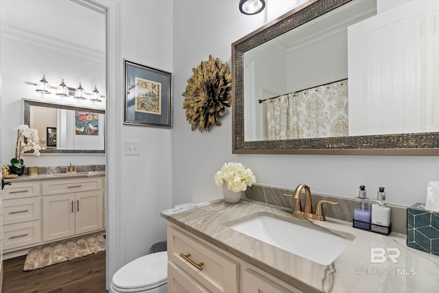 3250 Riviere Du Chien Rd, Mobile, AL 36693 - bathroom with wood finished floors, two vanities, and toilet